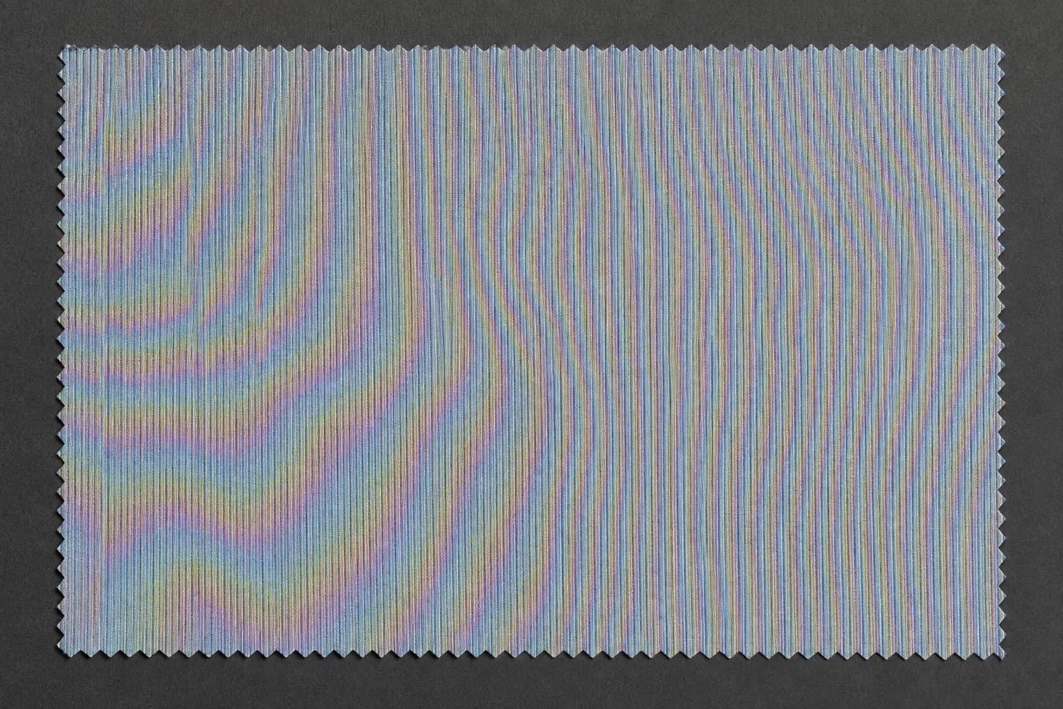 The same cloth from a middle distance: violent rainbow interference covers the surface.