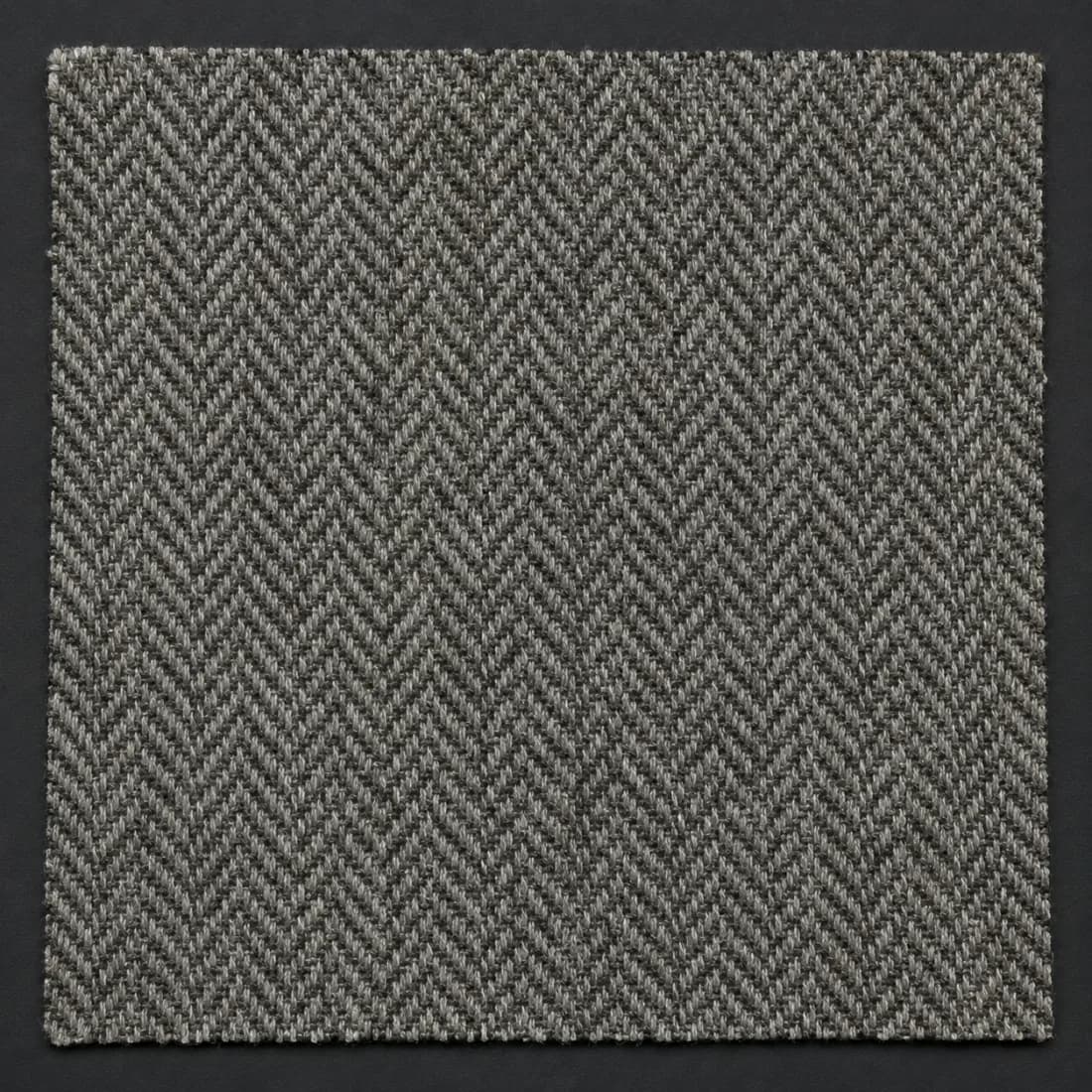 Fine herringbone tweed, photographed flat and close enough to separate the weave.