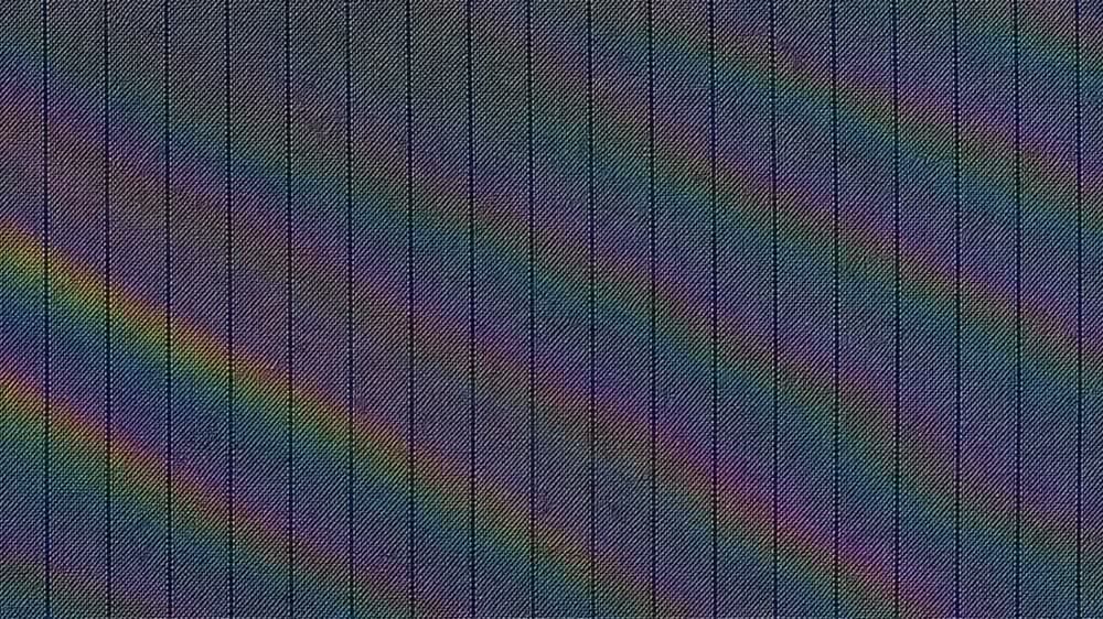 Navy pinstripe wool carrying broad rainbow interference bands that travel steadily across it.